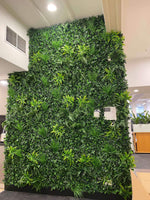 Green artificial plant wall in an indoor setting