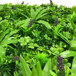 Artificial greenery with purple flowers on a white background