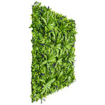 Artificial green leafy wall panel on a white background