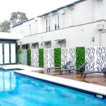 Modern pool area with lounge chairs and decorative wall panels.