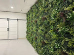 Green living wall in a modern indoor setting with white doors.