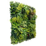 Artificial green wall with various types of plants on a white background