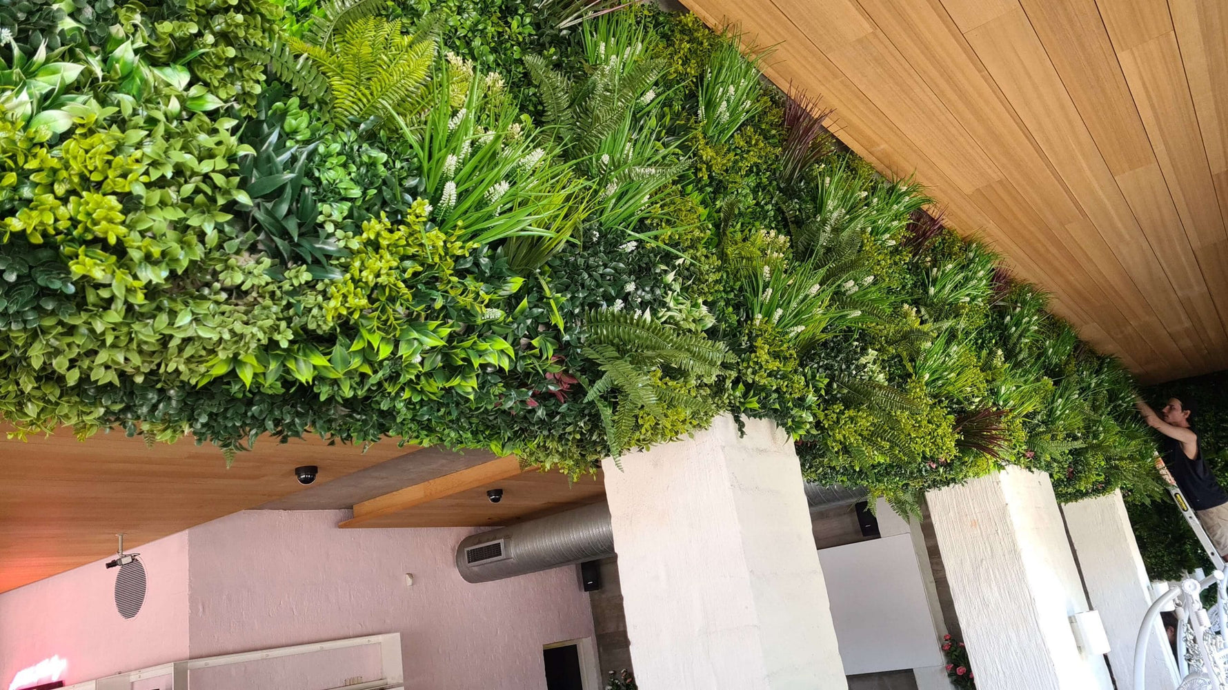 Green artificial foliage wall on a building facade