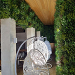 Decorative outdoor chairs with intricate designs in a garden setting