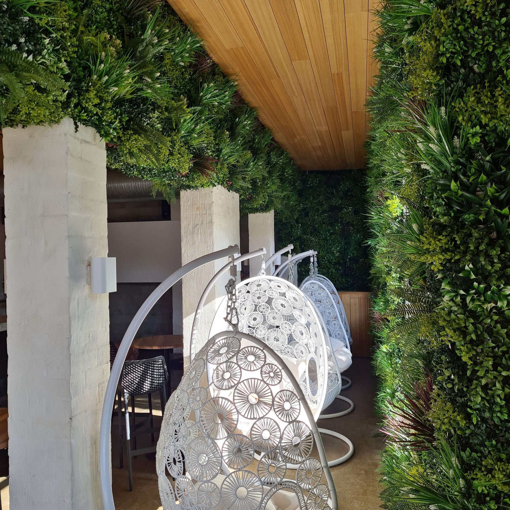 Decorative outdoor chairs with intricate designs in a garden setting