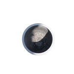 Round metallic object with two-tone finish on a white background