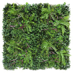 Artificial green wall panel with various green plants on a white background