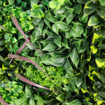 Close-up of artificial greenery with various shades of green leaves.