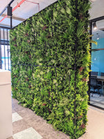 Green artificial plant wall in an indoor setting