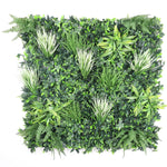 Artificial green wall panel with various types of greenery on a white background