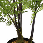Artificial potted plant with green leaves and dark stems on a white background
