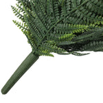 Close-up of artificial fern leaves on a white background