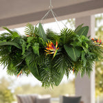 Hanging green plant with colorful flowers in a blurred indoor setting