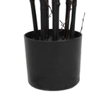 Black cylindrical pot with black sticks inside on a white background