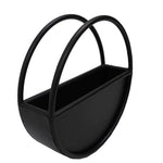 Black metal planter with curved handles on a white background