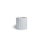 White ceramic planter with ribbed texture on a white background