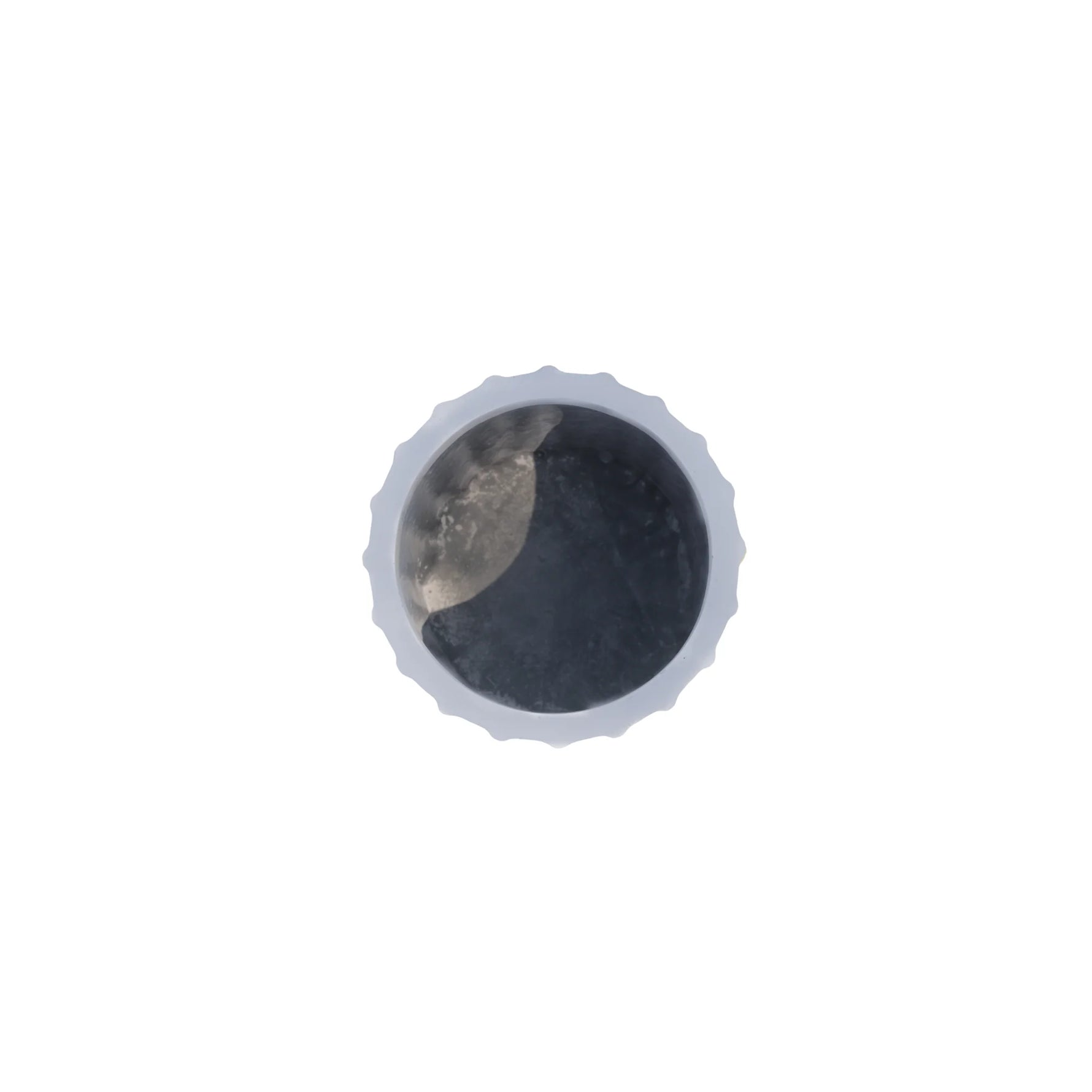 Round metallic object with a textured surface on a white background