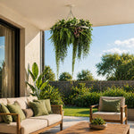 Outdoor patio with beige sofa, wooden armchair, and hanging plants on a sunny day.