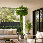 Outdoor patio with white sofa, armchair, and hanging plants