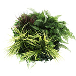 Artificial greenery arrangement with various plants on a white background