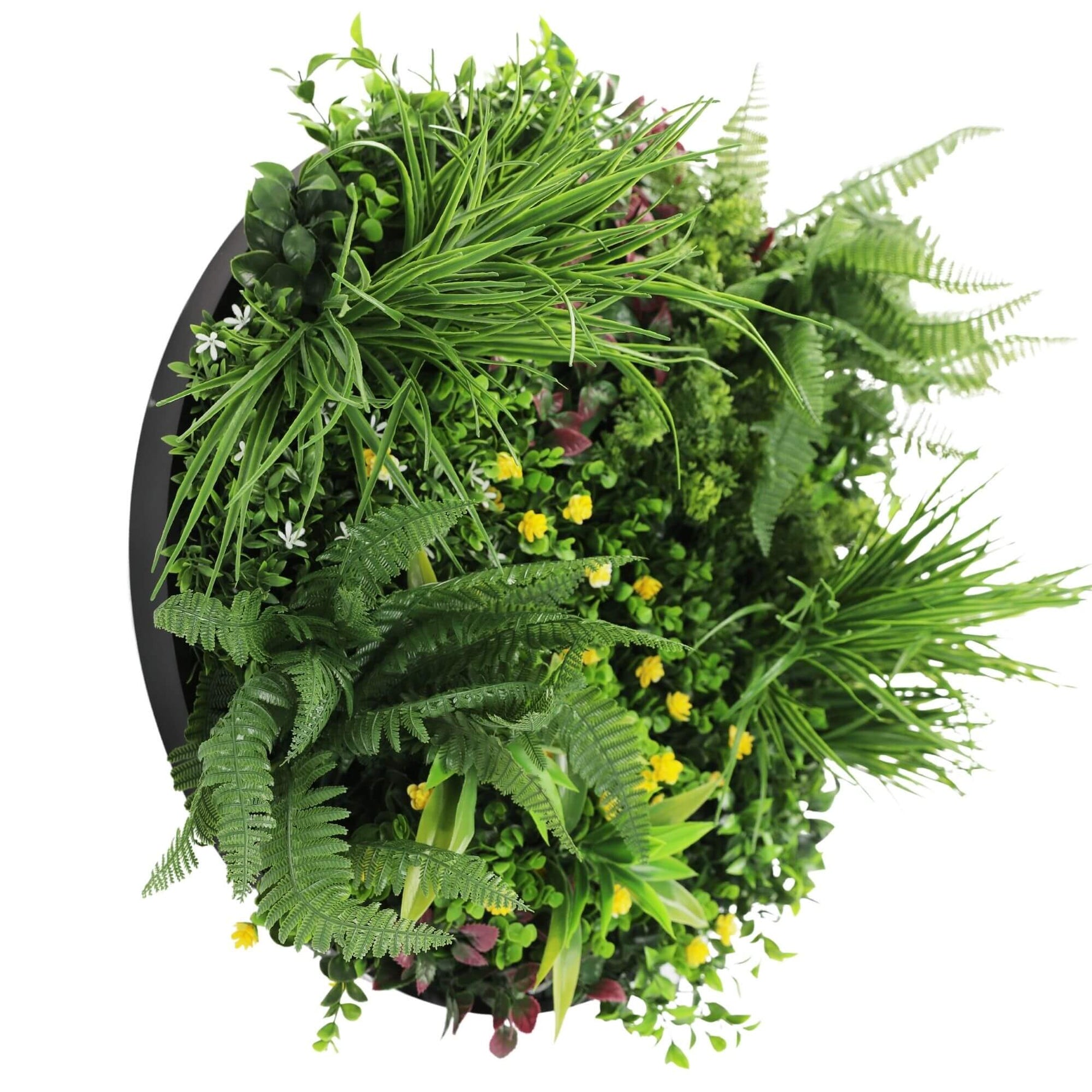 Artificial greenery arrangement with various plants on a white background