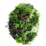 Artificial green wreath with various types of foliage on a white background