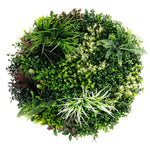 Artificial green wall with various types of plants on a white background