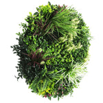 Artificial green wreath with various types of foliage on a white background