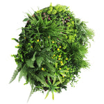 Artificial greenery wreath with various plants on a white background