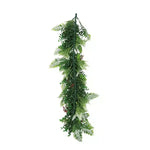 Artificial green leaf garland on a white background