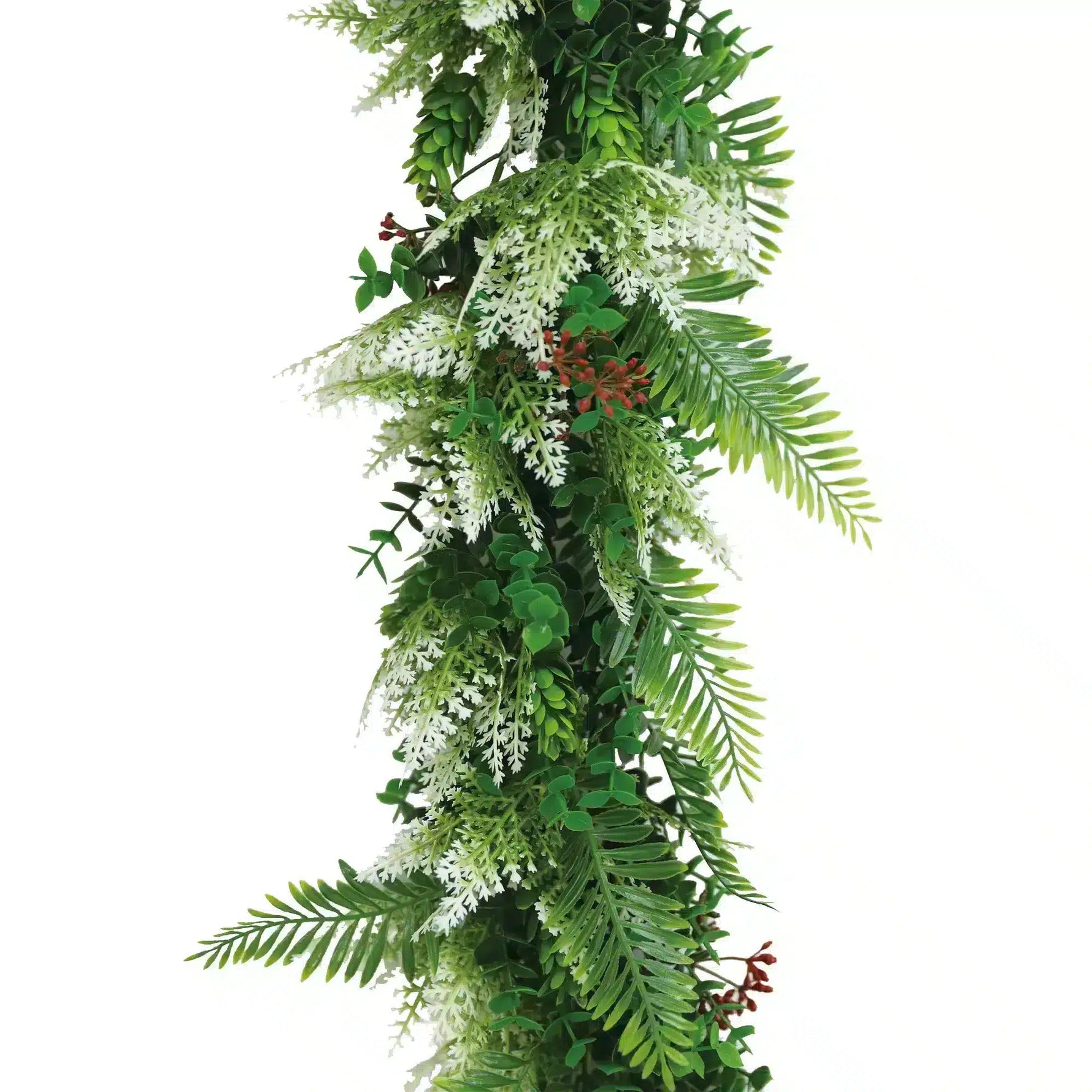 Artificial greenery garland with leaves and flowers on a white background