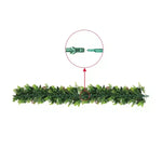 Artificial green garland with connectors on a white background