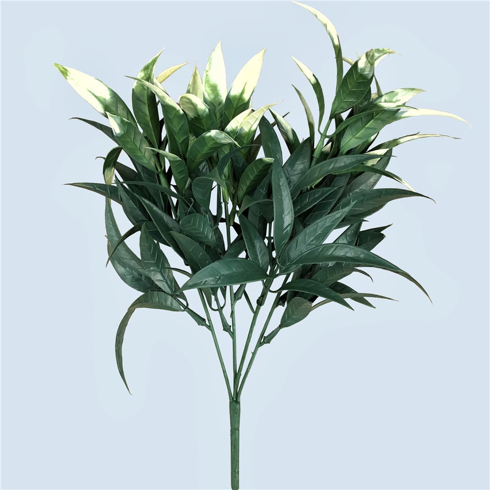 Artificial green leaf branch on a light blue background