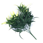 Artificial green leaf branch on a white background