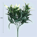 Artificial green leaf branch with a measurement indicator on a light blue background