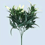 Artificial green leaf branch on a light blue background