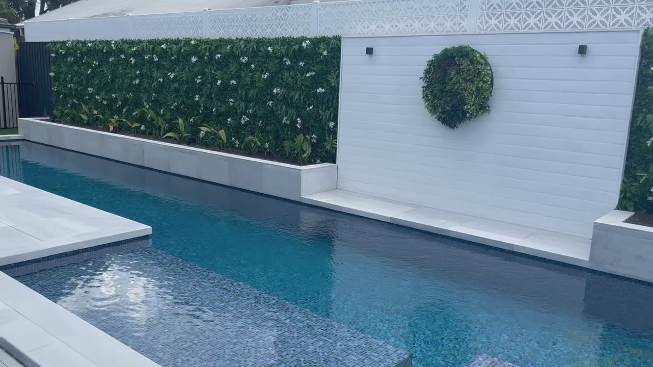 Artificial Flowering White Jasmine Fake Green Wall in a Pool Area